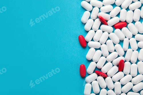 Preview: Heap Of Pills On Blue Background. Top View With Copy Space
