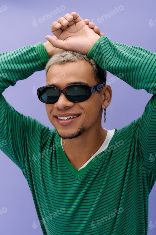Preview: Young african american man showcases trendy fashion against vibrant purple backdrop