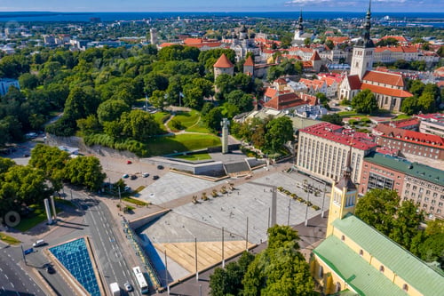 Preview: Drone view of the Cross of Liberty surrounded by buildings and trees in Tallinn, Estonia