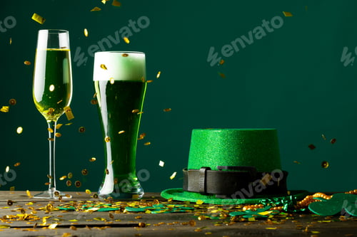 Preview: Image of beer and champagne glasses, green hat and copy space on green background