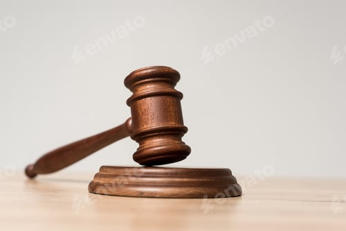 Preview: selective focus of gavel on wooden desk isolated on grey