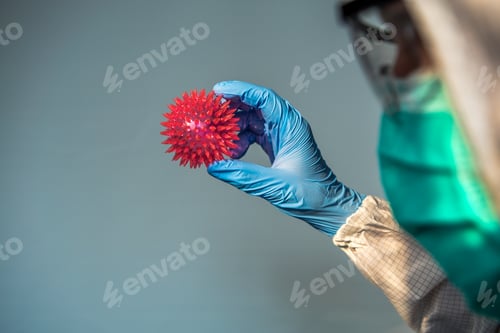 Preview: Medical Professional Holds Virus Model in Gloved Hand