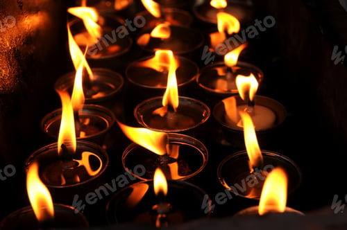 Preview: Butter lamps with flames near Bodhnath stupa in Kathmandu, Nepal