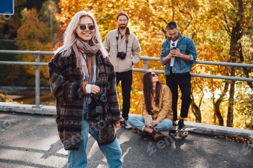 Preview: Four friends having a good time in autumn park