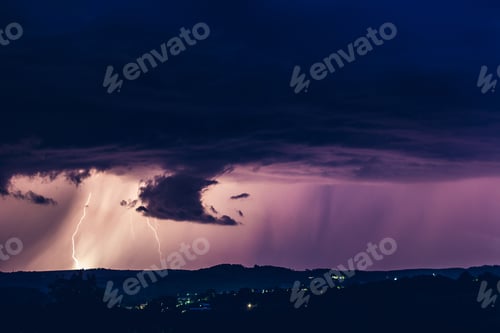 Preview: Night landscape on a background of thunderstorms. Rural silhouette and clouds with lightning flashes