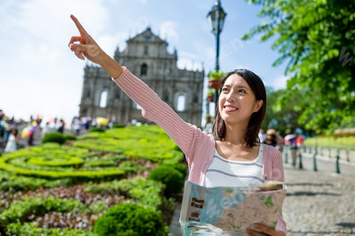 Preview: Woman holding city map and finger pointing far away