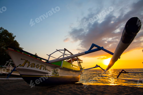 Preview: Silhouetted fishing boat at sunset on Senggigi beach, Lombok, Indonesia