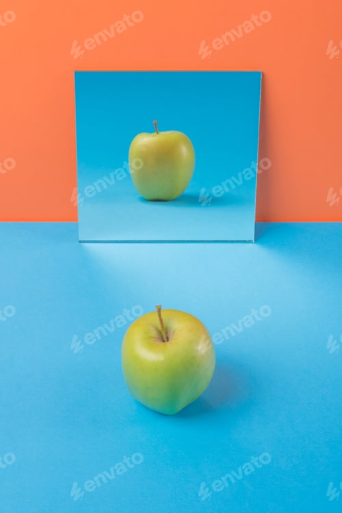 Preview: Apple on blue table isolated over orange background