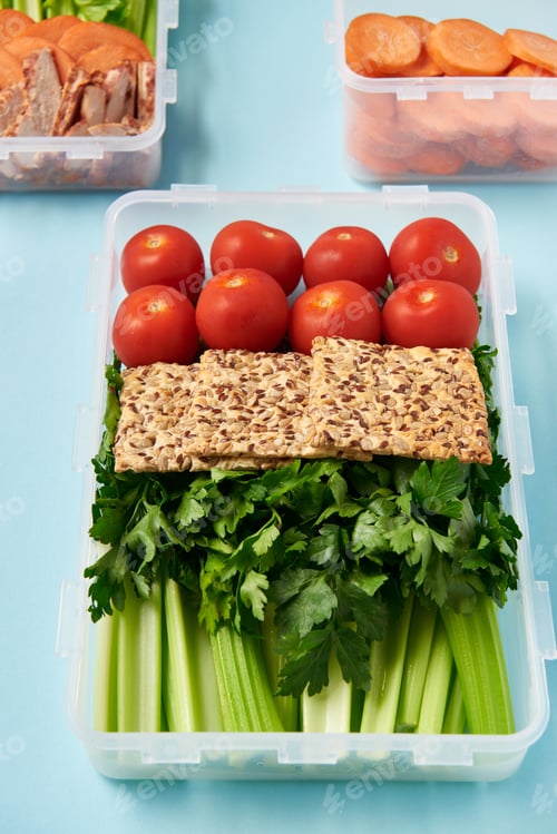 Preview: close up view of arrangement of food containers full of healthy vegetables, meat slices and cookies