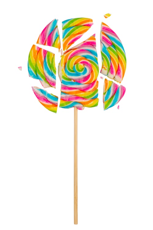 Preview: closeup of broken into pieces colorful lollipop candy on white background