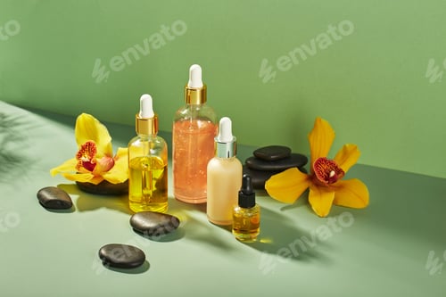 Preview: Cosmetic care products in glass bottles with orchid flowers - serums, cream, gel, oils. Concept for