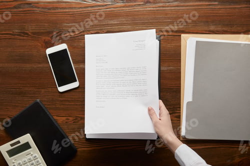 Preview: partial view of businessman holding document at workplace with copy space