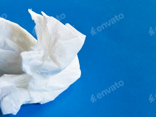 Preview: Image of used white tissue paper against blue background.