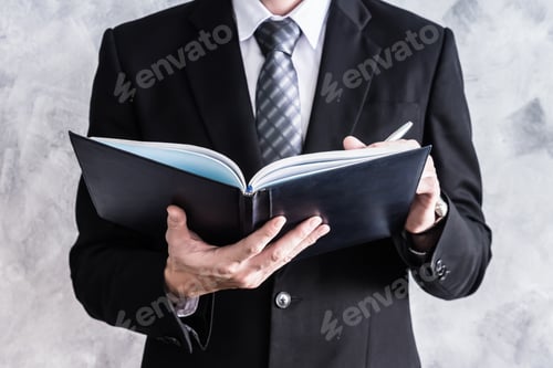 Preview: Close up of businessman checking documents on grunge background.