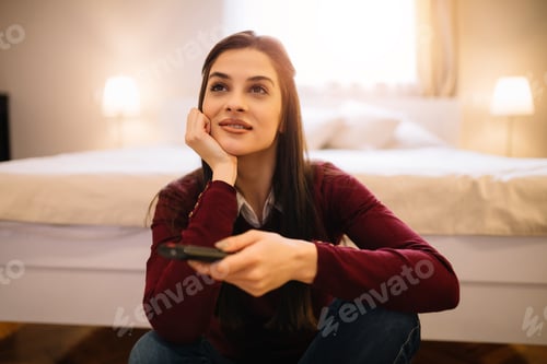 Young Woman Relaxing at Home Watching TV