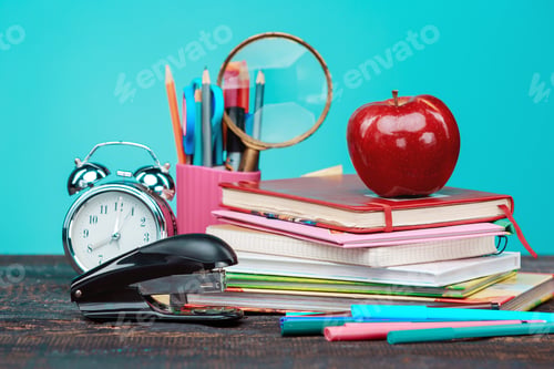 Preview: Back to School concept. Books, colored pencils and clock