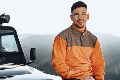 Preview: Portrait of a young caucasian man hiking in the mountains