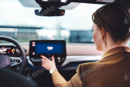 Preview: Businesswoman waiting on the sidewalk to be picked up by an electric car driver
