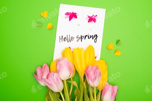 Preview: Top view of bouquet, card with hello spring lettering and decorative hearts on pink