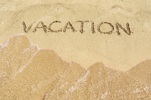 Preview: The Word Vacation Is Written By A Closeup On The Sandy Surface Of The Beach Or Coast