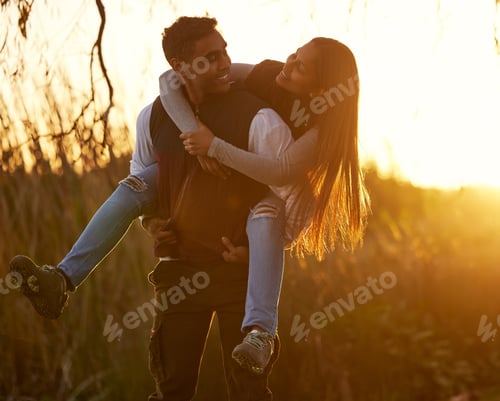 Preview: Youve become so strong lately. Shot of a young man giving his girlfriend a piggyback ride.