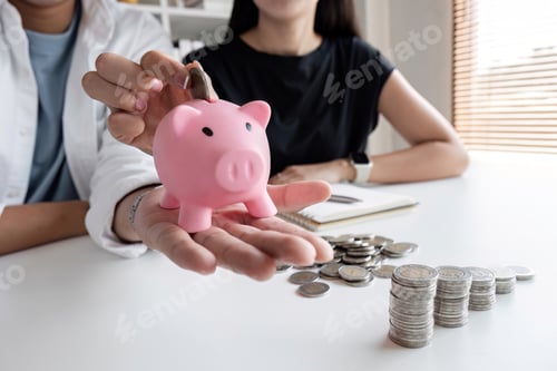Preview: A committed Asian couple saves money together. Counting the coins in the piggy bank