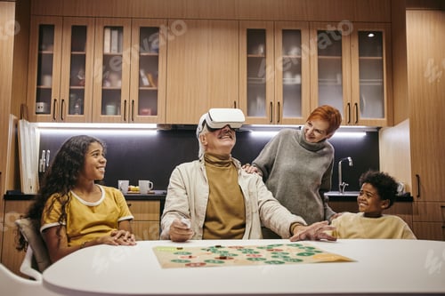 Preview: Two cute siblings and their grandmother looking at mature man in vr headset