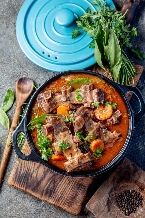 Preview: Beef ribs Bourguignon. Beef ribs stewed with carrot, onion in red wine. France dish. Top view