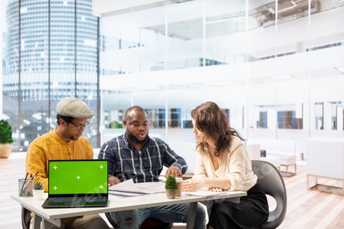 Preview: Businessman discussing with the real estate agents next to chroma key