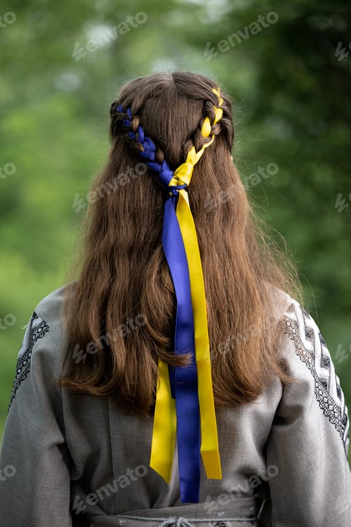 Preview: A girl with a blue and yellow ribbon in an embroidered shirt as a symbol of Ukraine