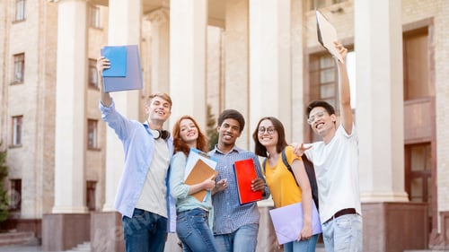Preview: Cheerful Diverse Students Posing Standing Outside University Building