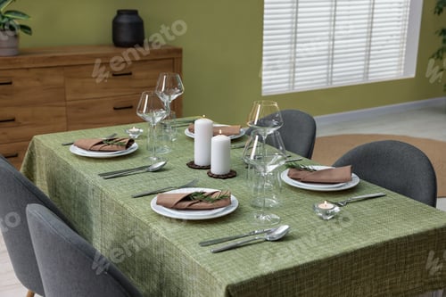 Preview: Stylish table setting with olive tablecloth, glasses and candles indoors