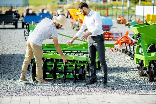 Preview: Agronomist with salesman at the shop with agricultural machinery
