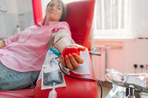 Preview: Young woman making blood donation in hospital. Blood donation.