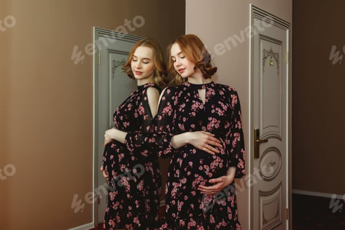 Preview: A woman celebrates her pregnancy in a quiet indoor