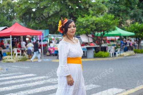 Preview: Mexican woman in traditional white dress during Mexican Independence Day celebration.