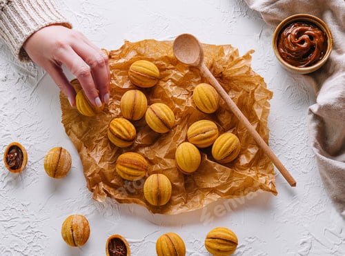 Preview: Hand picking a homemade walnut cookie