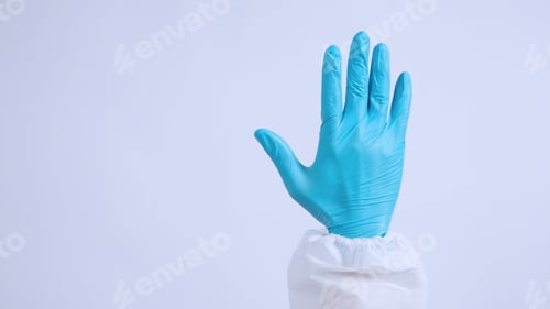 Preview: Blue Gloved Hand Stopping Against a Light Background