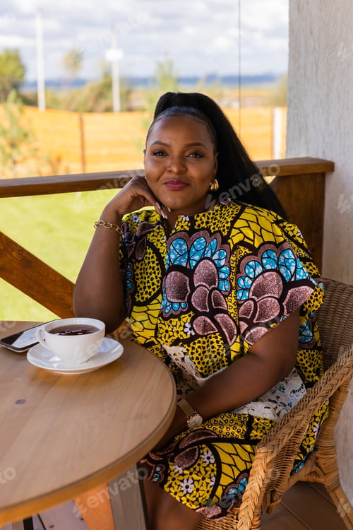 Preview: African american woman drinking tea on cozy balcony or terrace wooden country house in weekend on