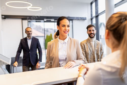 Preview: Businesswoman arriving in a hotel with her colleagues for a business conference.