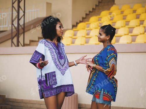 Preview: Portrait of young Afro women have conversation outdoors