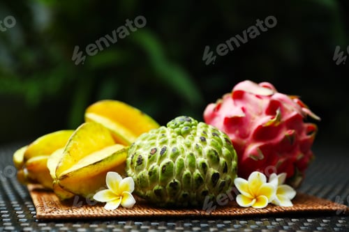 Preview: Different tropical fruit on wicker table outdoors, closeup. Space for text