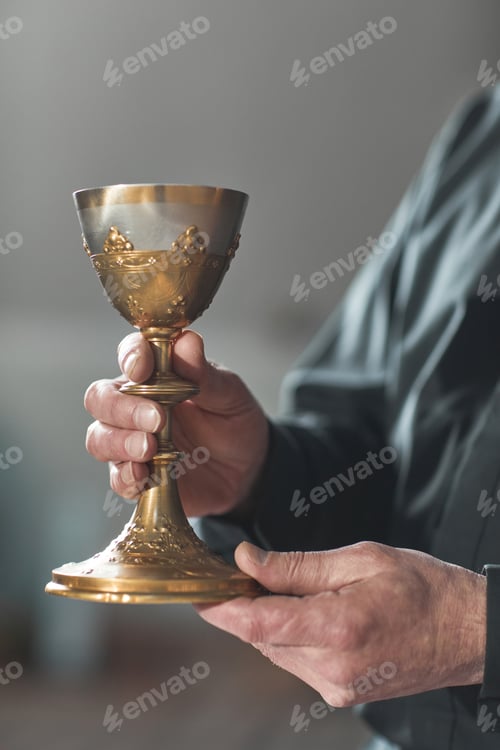 Preview: Priest holding the cup with wine
