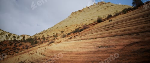 Preview: Hills and mountains under a blue sky with clouds above in Zion National Park in the early Spring