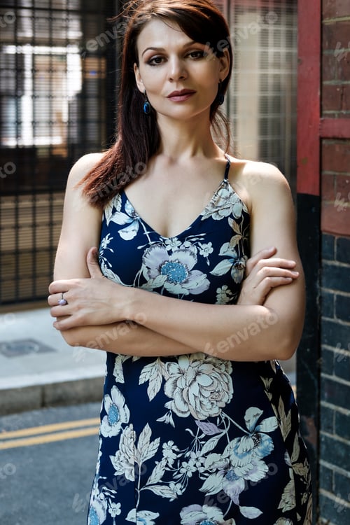 Preview: Beautiful mature woman posing in the street.