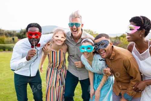 Preview: Portrait of happy african american couple with diverse friends embracing during wedding