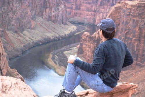 Preview: A man sitting by the rock enjoying the beauty of Glenn Canyon