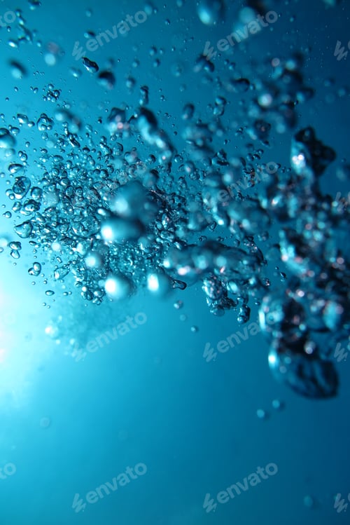 Preview: Closeup shot of emerging from deep-sea bubbles going towards the sunlight