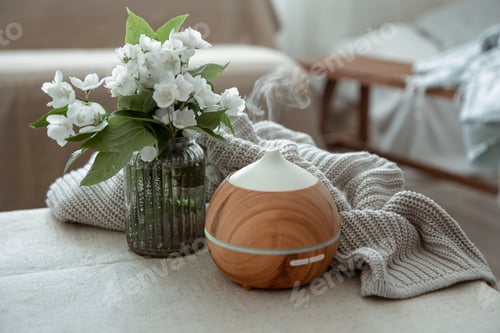 Preview: Cozy home composition with air humidifier and flowers in a vase.