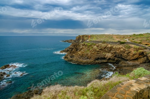 Preview: Dramatic view of the volcanic coastline in El Sauzal Tenerife featuring a stone promenade